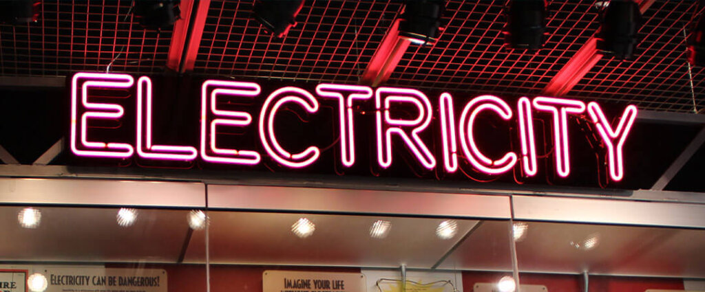 An exhibit with the label ELECTRICITY in pink lights